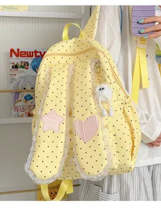 Sweet polka dot backpack detail, cute bunny ears design with delicate lace trim.
