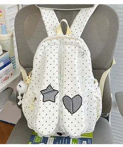 Detailed view of sweet polka dot lace bunny ear backpack with cute star and heart patches.