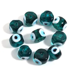 Glass evil eye beads detail view, turquoise flat round DIY bracelet jewelry charm accessory.