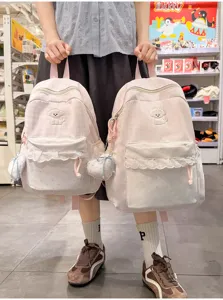 Roze geruite schoolrugzak met schattig hondenborduursel, kanten zak en hartvormige hanger.