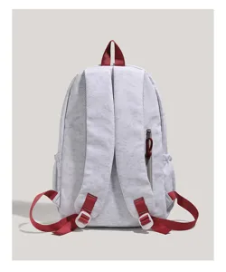 Detailed view of grey backpack with red straps and side zipper pocket, lightweight design.
