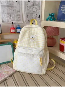 Schattige gele ruitjes rugzak voor meisjes, met witte stipjes voorzak en kanten afwerking.