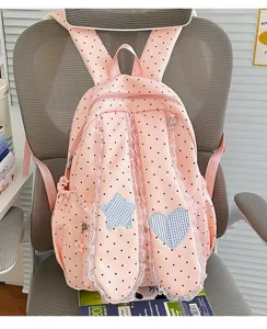 Cute pink polka dot backpack detail featuring sweet lace trim and bunny ears with star heart patch.