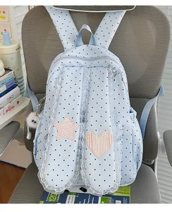 Detail view of sweet polka dot backpack featuring cute lace trim and star heart patches.