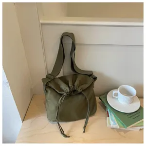 Vue détaillée du sac bandoulière décontracté unicolore à cordon, grand sac unisexe.