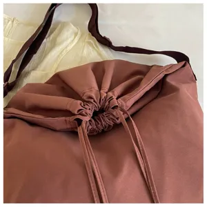 Détail du sac bandoulière à cordon, tissu souple, sangle réglable, grand style hobo.