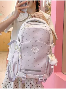 Gedetailleerd overzicht van de schattige roze rugzak met sterren, patch en pluche hanger.