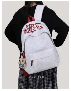 Casual embroidered letter backpack, stylish student school bag with cute bear pendant.