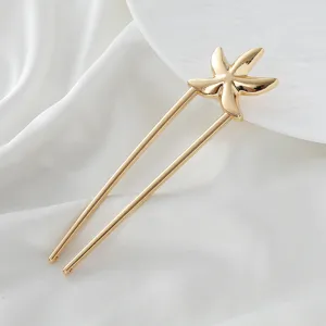 Gold starfish U-shaped hairpin detail shot, minimalist hair styling accessory for daily or traditional wear.