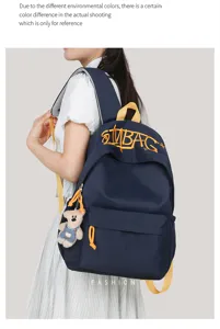 Dark blue canvas backpack for women students large capacity school bag with cute bear pendant.