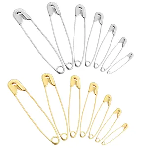 Assorted safety pins set, metal gold and silver clothing pins in various sizes for sewing.