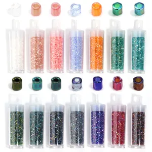 Detailed view of colorful tubular glass seed beads in transparent tubes for DIY jewelry making.