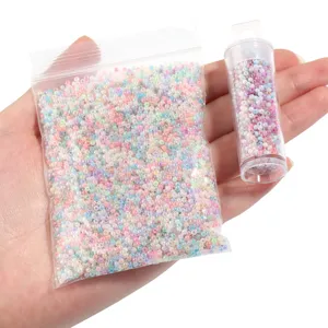 Detail shot of colorful glass seed beads in a ziplock bag and a clear tube for DIY crafts.