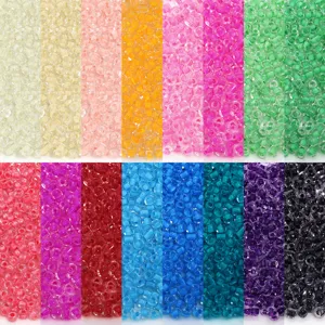 Detailed view of colorful glass seed beads showing vibrant translucent core color variations.