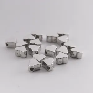 Detailed view of shiny silver heart spacer beads, ideal for custom DIY charm bracelet making.