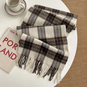 Detailed view of cozy winter plaid wool scarf featuring classic check pattern and fringe.