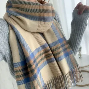 Cozy winter plaid cashmere-feel scarf detail, elegant tassel design and soft warm fabric texture.