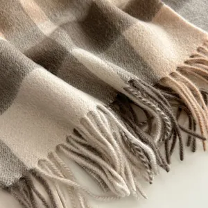 Cozy wool plaid scarf with stylish fringe, perfect for autumn and winter warmth and comfort.