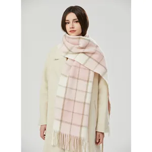Cozy mohair plaid winter scarf draped over a classic coat, elegant cold weather accessory.