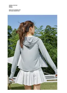 Detail view of lightweight gray hooded sun protection jacket paired with white skirt.