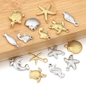 Detailed view of assorted stainless steel marine animal charms, gold and silver DIY jewelry.