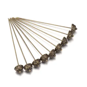 Metal flower head pin jewelry findings, vintage bronze alloy DIY craft accessory detail shot.