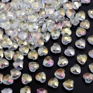 Close-up detail of iridescent crystal heart beads with faceted cut for DIY jewelry making.