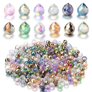 Close-up of faceted glass crystal teardrop beads with colorful gradient details for DIY craft.