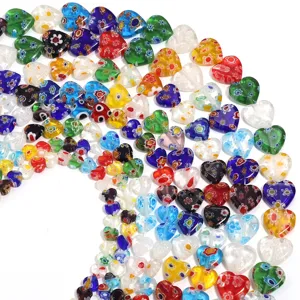 Close-up of colorful millefiori glass heart beads showing intricate floral pattern details.