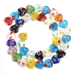Close up of colorful millefiori glass heart beads, perfect for DIY jewelry making accessories.