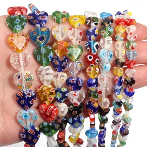 Close-up detail of colorful millefiori glass heart beads for DIY bracelet jewelry making accessories.