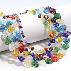 Detail shot of colorful millefiori glass heart beads, perfect for DIY jewelry and bracelets.