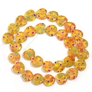 Details of yellow heart millefiori glass beads for DIY bracelet and necklace jewelry crafting.