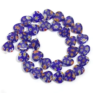 Detail view of blue millefiori glass heart beads showing vibrant floral pattern texture.