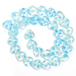 Transparent glass heart beads with blue floral pattern for DIY jewelry making and bracelets.