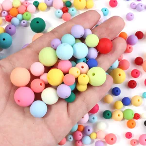 Close-up detail of colorful round rubber paint DIY acrylic craft beads, smooth tactile finish.