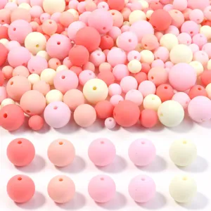 Detailed view of assorted 6-16mm pastel pink and cream acrylic beads for DIY jewelry making.