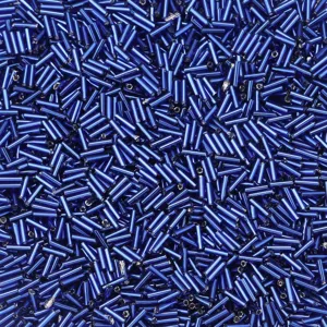 Primo piano dettagliato di perline tubolari in vetro blu brillante, ideali per gioielli fai da te.