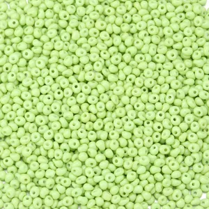 Close-up detail of light green glass drop seed beads, ideal for DIY jewelry making crafts.