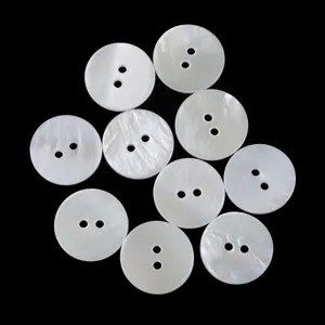 Detailed view of natural white mother of pearl two-hole buttons, perfect for shirts and knitwear.