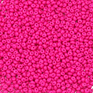 Detailed close-up view of vibrant hot pink teardrop glass seed beads for DIY jewelry making.