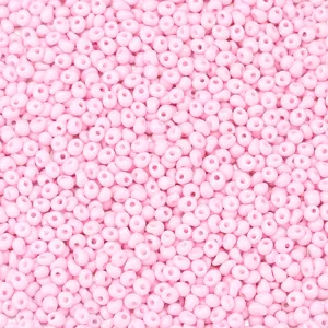 Close-up of pastel pink waterdrop glass seed beads, ideal for DIY jewelry making and crafting.