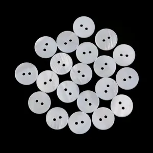 Close-up detail of natural white mother of pearl two-hole buttons for shirt sewing accessories.