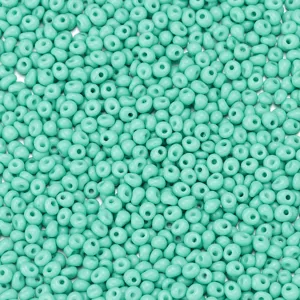 Close-up detail of 4x5mm turquoise glass seed beads texture, loose drop beads for DIY jewelry making.