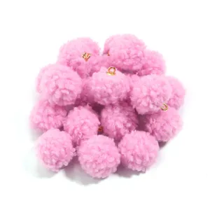 Detailed close-up of fluffy 20mm pink teddy fleece pom pom charms with gold hanging loops.