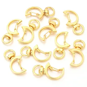 Close-up detail of gold crescent moon metal lobster clasps for DIY handmade jewelry accessories.