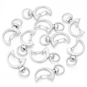 Close-up view of silver moon-shaped swivel snap hooks for DIY handmade keychains and bags.