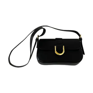 Black patent leather shoulder crossbody bag with gold horseshoe buckle for women daily fashion.