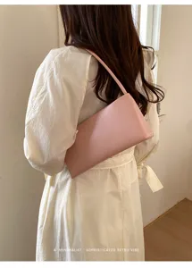 Minimalist pink PU leather underarm shoulder bag for women, chic retro rectangular handbag.