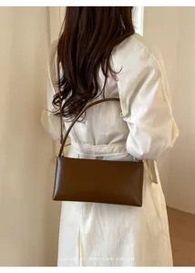 British retro PU shoulder bag, minimalist rigid underarm bag for women with chic brown finish.